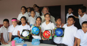 Giving donated soccer balls at Quimixto school